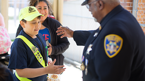 Safety patroller interacting with a police officer