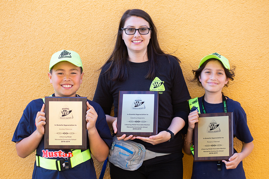 Safety patrollers holding awards