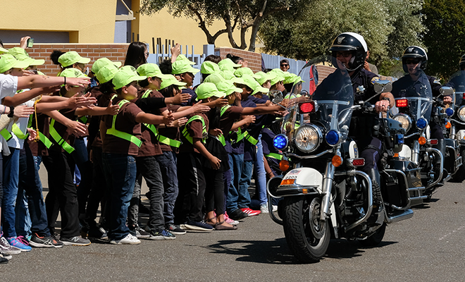 Group of safety patrollers with motorcycle police officers